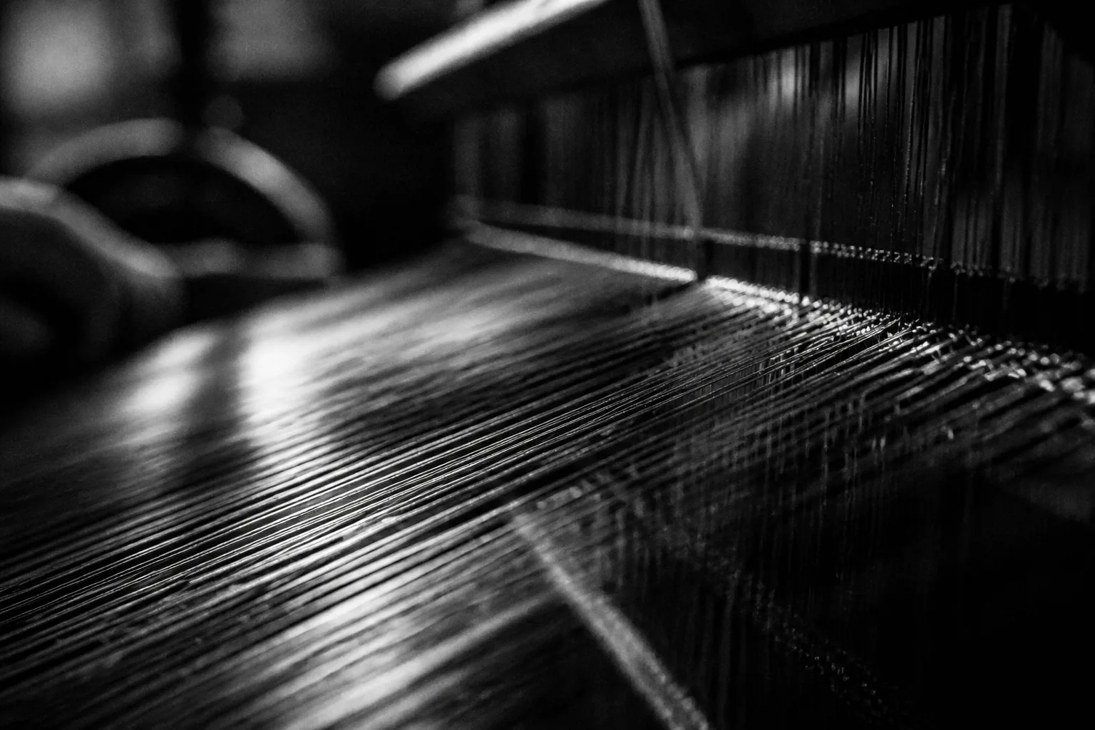 Threads on a loom, woven into structure
